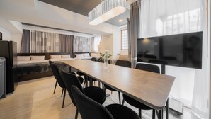 A modern hotel room with a large bed, a dining table, a sofa, a TV, and a large window with curtains. - HOTEL LEGALIE Osaka Shinsaibashi North (Osaka)