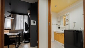 A compact living space with a kitchenette, a dining area, and a bathroom. - HOTEL LEGALIE Osaka Shinsaibashi North (Osaka)