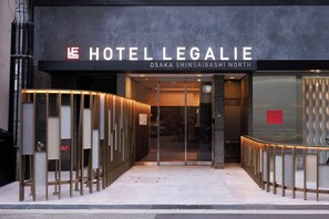 The entrance to Hotel Legalie with a modern design, including a glass door and a metal railing. - HOTEL LEGALIE Osaka Shinsaibashi North (Osaka)