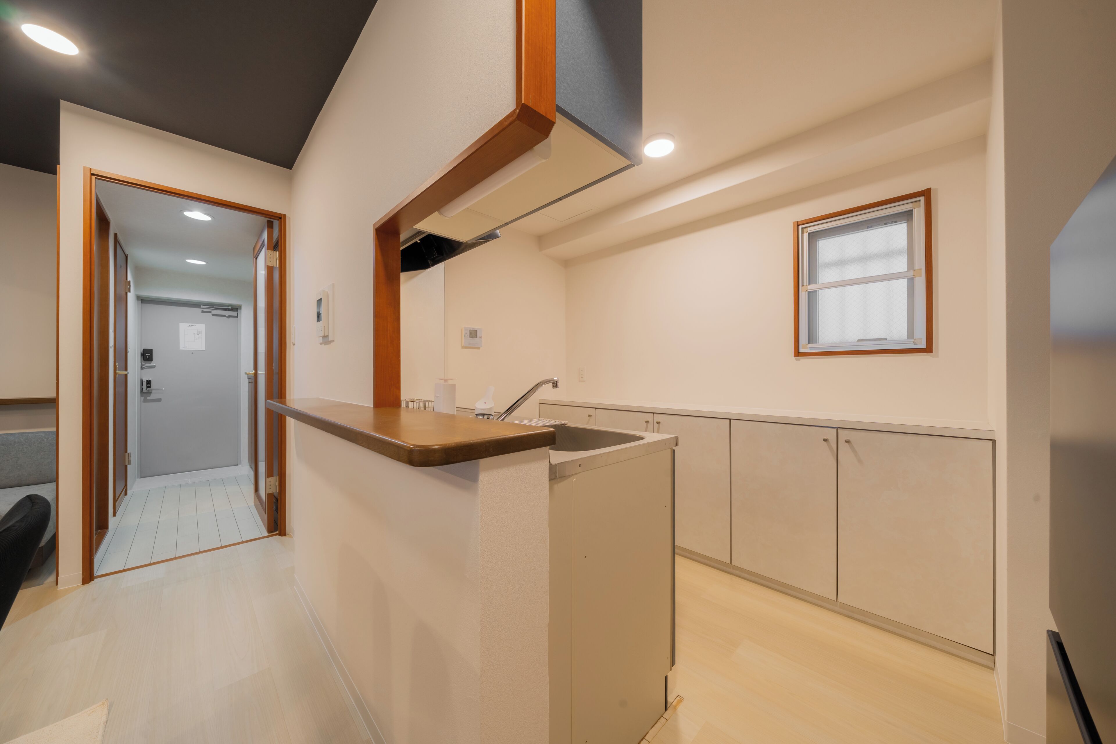 A modern kitchen with a wooden countertop, a built-in sink, and cabinets.
