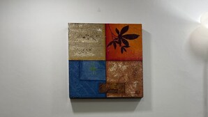 A wooden chair in a room with a textured wall art piece above it. - Apartment near the airport, modern shopping malls and entertainment centers (Bogotá)