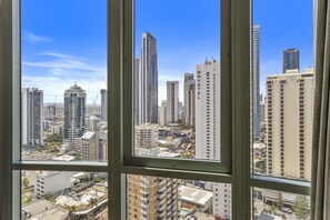 A cityscape through a window with high-rise buildings, including a Novotel hotel. - Bright Apartment Near Surfers Paradise Beach (Gold Coast)