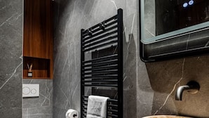 A modern bathroom with a marble wall, a black towel warmer, a round sink, and a toilet. - 151. Luxury suite-Etienne Marcel-Châtelet-Paris 3 (Paris)