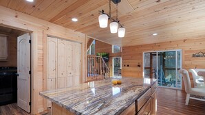 Ein Holzinterieur mit Kücheninsel, Holzausstattung und einem Essbereich mit einer Bank.