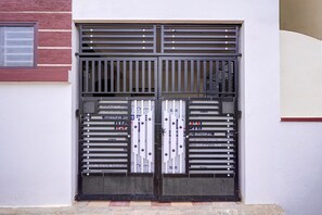 A double door with metal bars and a window to the left. - Classic Seven Hills (Bengaluru)