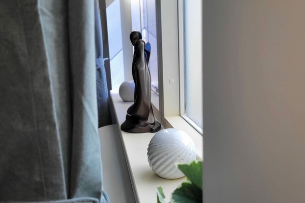 Take a glimpse through a captivating window display showcasing art that boldly celebrates unity and harmony among people, creating a striking visual statement.