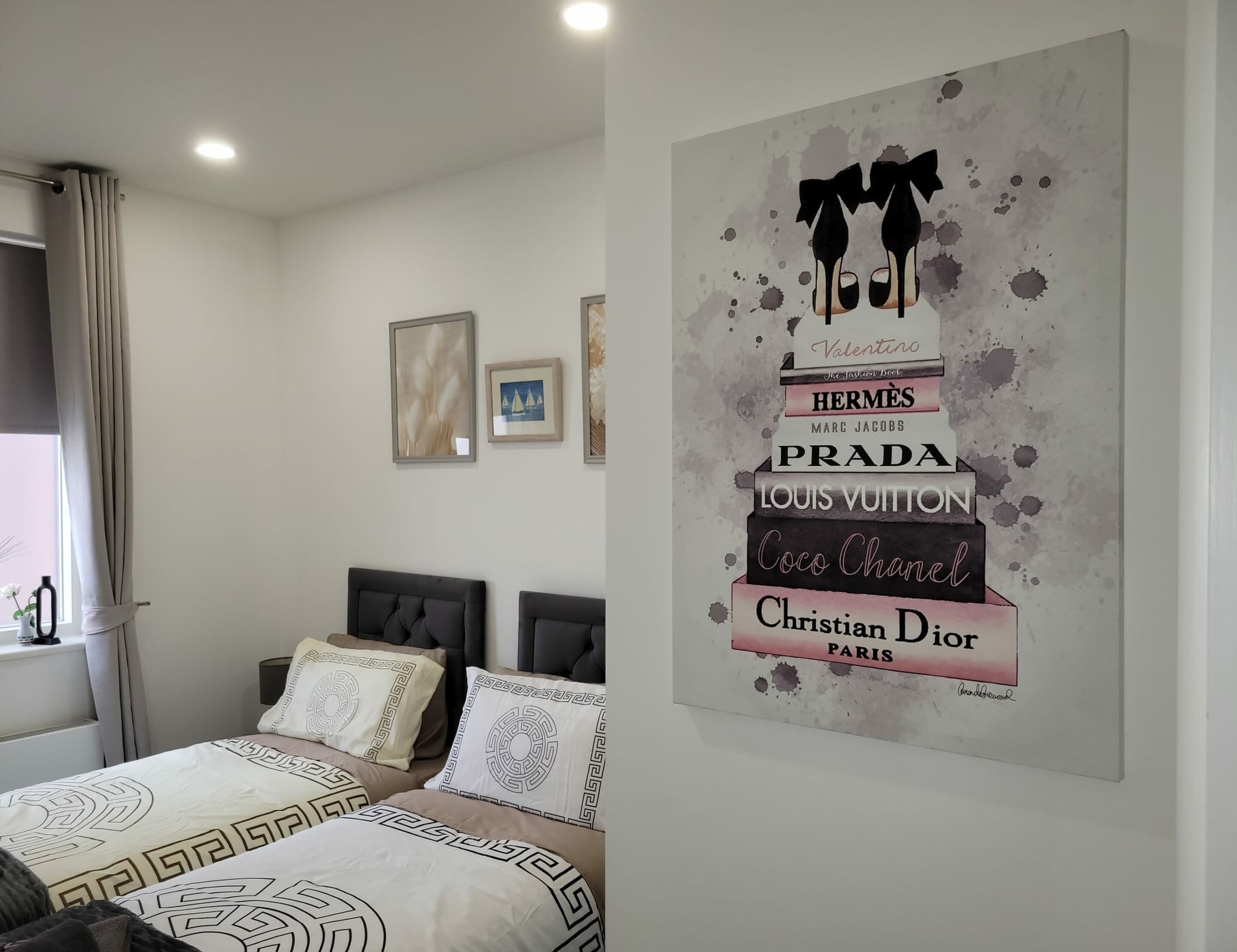 Two single bed in grey colour scheme is inspired by the lounge sofa-bed, complemented by the side table, bed lamp, and throws. The cream duvet and pillowcases pick up the soft, luxurious tones of the cosy lounge rug, creating a harmonious and inviting space.