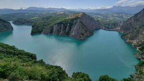 A mountainous landscape with a large body of water surrounded by cliffs.