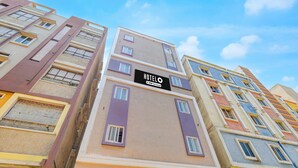 A multi-story hotel building with a sign indicating it is serviced by a specific company. - Classic Hotel Gandimaisamma (Hyderabad)