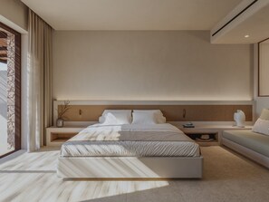 A modern bedroom with a large bed, bedside tables, a sofa, and a large window. - ONERO (Milos)