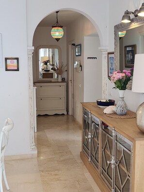 A hallway with a wooden console table, a mirror, and a hanging lamp. - Villa Buena Vista, pool and seaviews (AN)