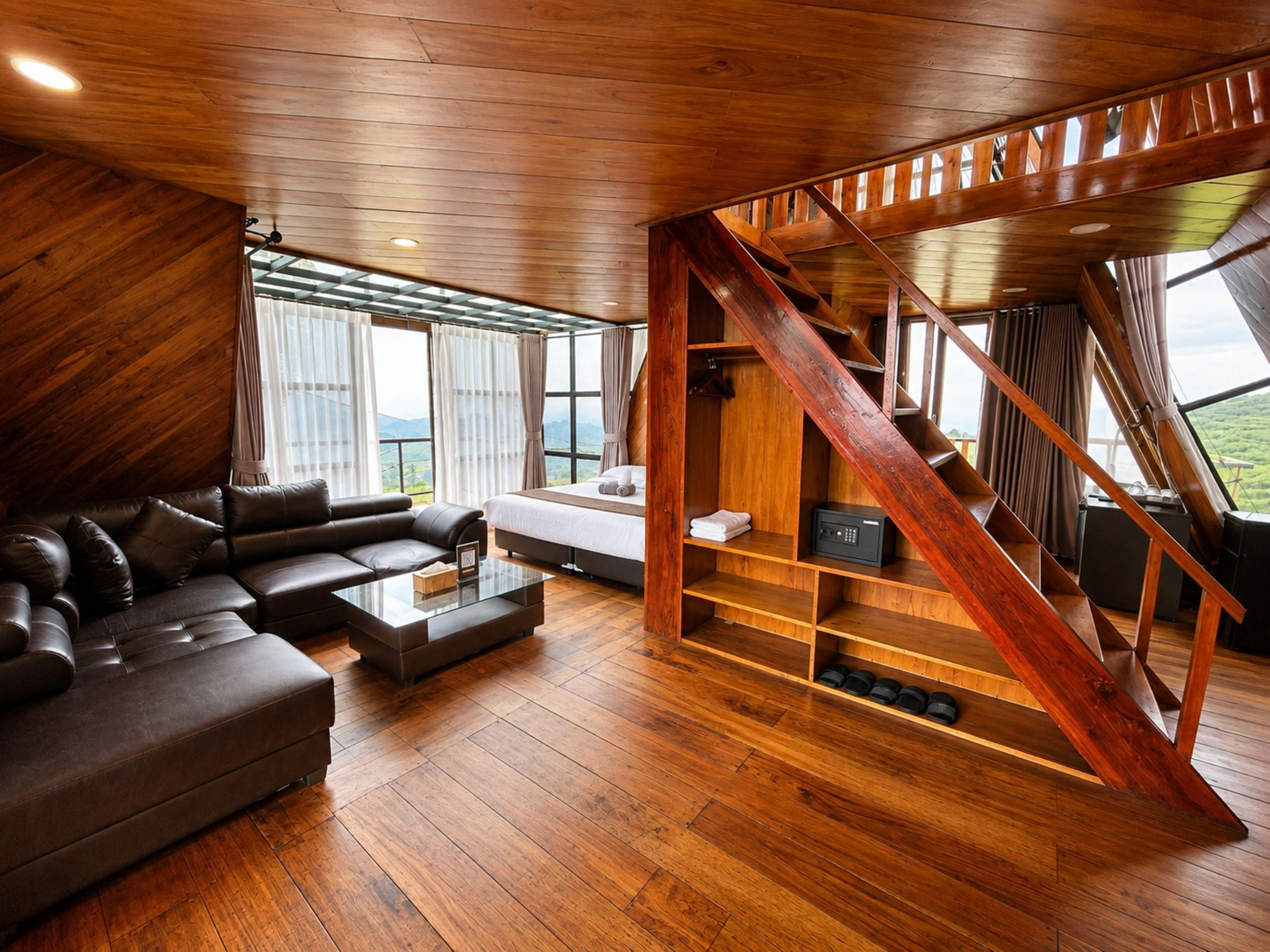A modern interior with a wooden staircase, a leather sofa, and a bed.