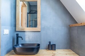A modern bathroom with a black vessel sink, wooden countertop, and a mirror with a wooden frame. - Large Holiday Villa With Sauna and Mountain Views (Bukowina Tatrzanska)