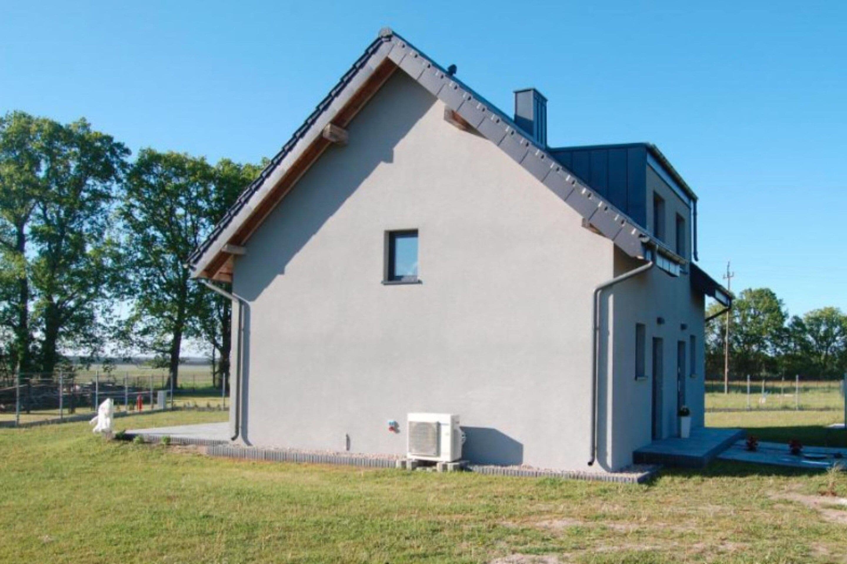 A single-story building with a gabled roof, a small window, and a door.