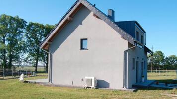 A single-story building with a gabled roof, a small window, and a door.