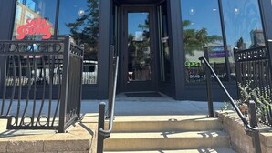 A modern building with a storefront labeled 'neverbetter MARKET + WELLNESS.'