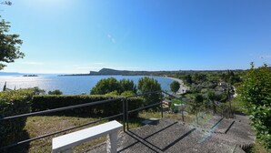A scenic view of a coastal area with a clear sky, a body of water, and a distant mountain. - MGH- AMAI Small Holiday Cottage (Manerba del Garda)