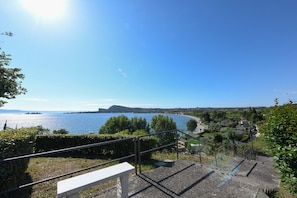 A scenic view of a coastal area with a clear sky, a body of water, and a distant mountain. - MGH- AMAI Small Holiday Cottage (Manerba del Garda)
