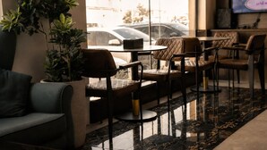 A modern indoor seating area with leather chairs, a sofa, and a potted plant. - HMM Serviced Apartments Taybah Jeddah (Jeddah)