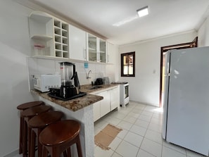 A kitchen with a coffee maker, a stove, a refrigerator, and a window. - Dwelling place of Israel, Revelation 30 (Porto Seguro)