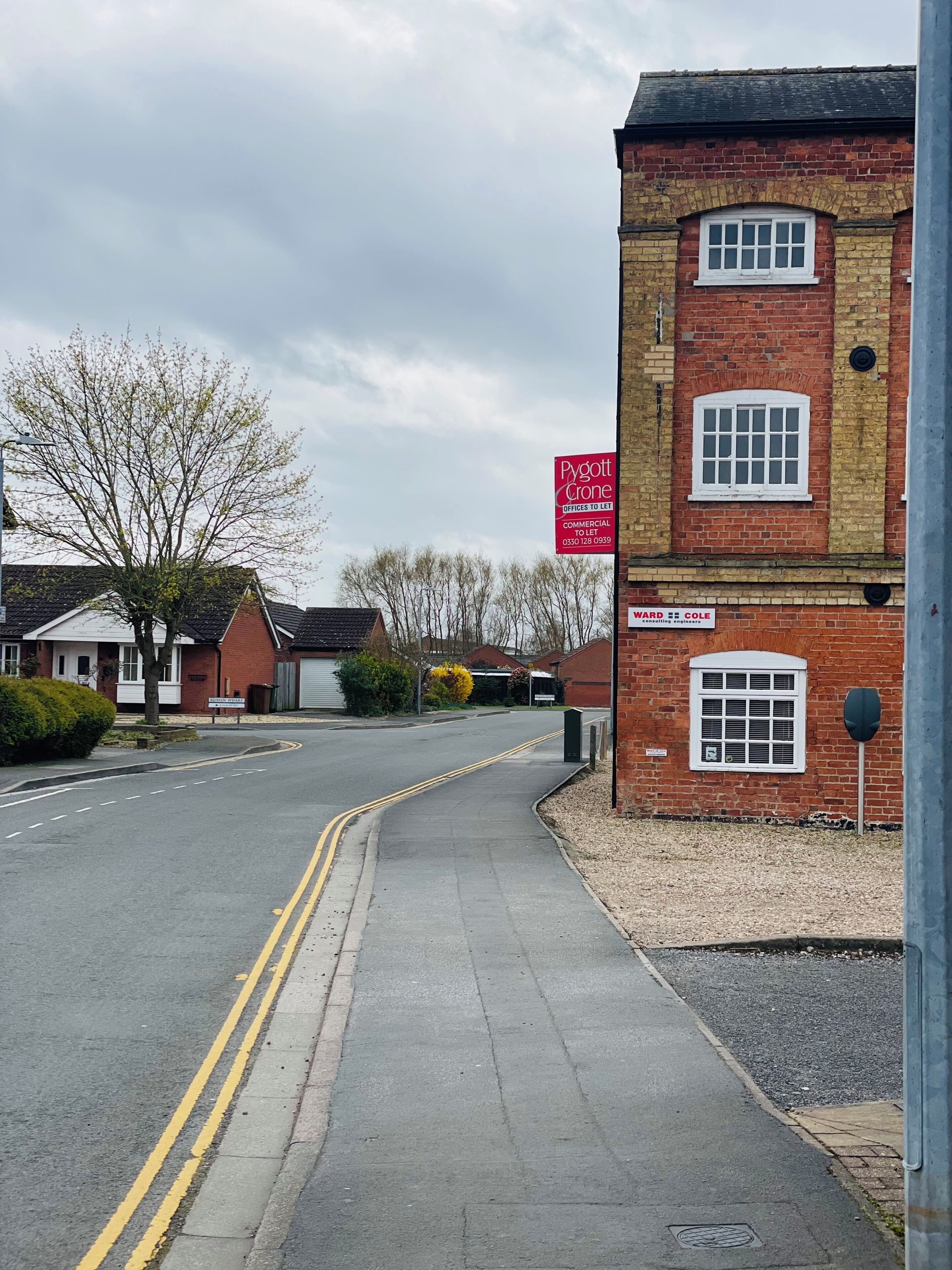 A street view with a red brick building labeled 'Pygott Crone Offices to Let' and a sign for 'Cole Consulting Engineers.'