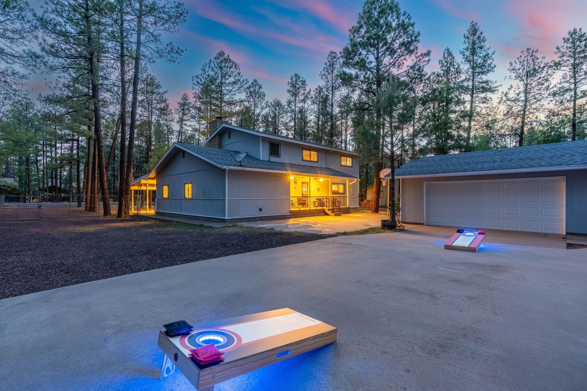 A modern house with a garage, a heated outdoor floor, and a heated shuffleboard table.