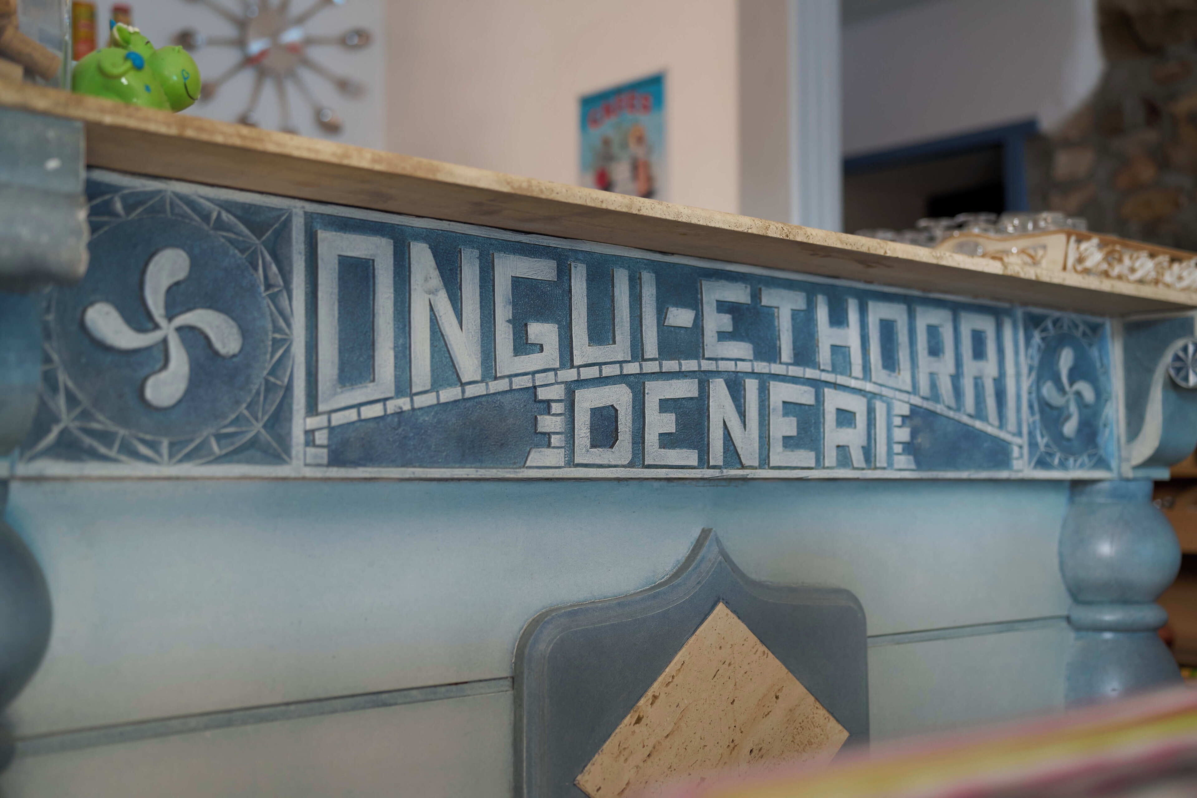 A blue and white tiled wall with the inscription 'ONGU-ETHORAN DENERIE.'