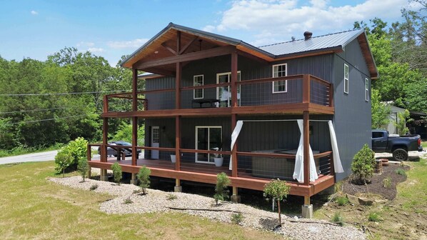 A two-story house with a balcony, a deck, and a garage.