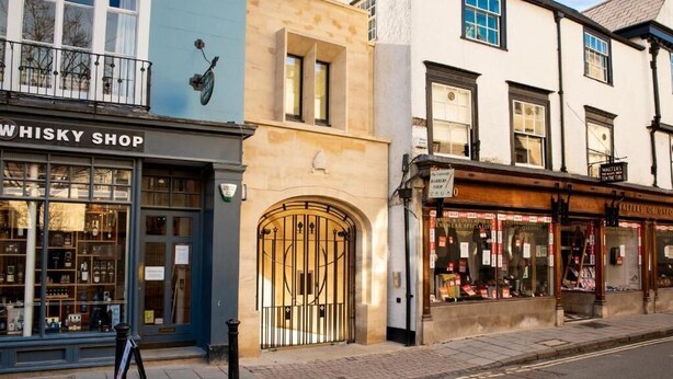 A street view with a shop named 'WHISKY SHOP' and another shop with a sign 'WALTERS'. - Turl Street Mitre (Oxford)