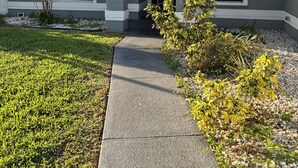 A residential house with a grey exterior, a front porch, and a pathway leading to the entrance. - Tropical Oasis, 3 Bedroom house with pool. (Palm Bay)