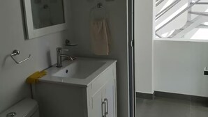 A modern bathroom with a toilet, sink, and mirror. - De-stress in the tranquility of the beautiful bay (Pucusana)