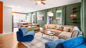 A living room with a sofa, coffee table, and a ceiling fan.
