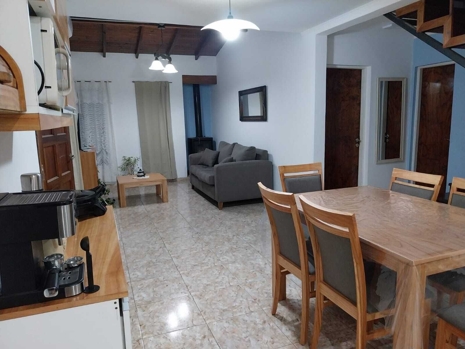 A compact living space with a kitchen, dining area, and seating area.. mar de cobo refugio entre el lago y el mar