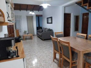 A compact living space with a kitchen, dining area, and seating area.
