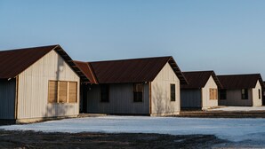 A row of single-story buildings with pitched roofs and large windows. - Secluded Ranch Stay up to 4 | Near Garner State Park and few steps to Frio River (Concan)