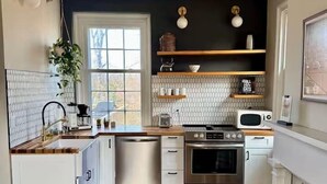 A kitchen with white cabinets, a dishwasher, an oven, and a microwave. - Historic DT Building, Walk to Shops & Dining (Lynchburg)