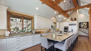 A spacious kitchen with a large island, white cabinetry, and a wooden ceiling. - BRAND NEW - Luxury Beaver Creek Mountain Retreat - Sleeps 16 (Edwards)
