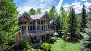 A large, multi-story house with a balcony, surrounded by lush greenery and trees. - BRAND NEW - Luxury Beaver Creek Mountain Retreat - Sleeps 16 (Edwards)