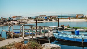 A dock with boats, a small pier, and houses in the background. - Appartement T2 en résidence - Gruissan, France 2 travellers. (Gruissan)