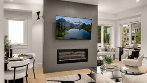 Una sala de estar moderna con un televisor de pantalla plana montado en la pared, una chimenea debajo y un comedor con mesa y sillas.