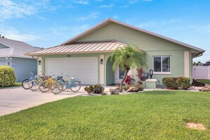 A single-story house with a garage, a covered porch, and a well-maintained lawn. - Heated Pool & Hot Tub, Walk to Beach, Fully Equipped. Free Bikes. Grill. (Naples)