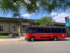 A vintage red and blue bus parked in front of a building labeled 'Starved Rock Lodge.'