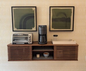 A kitchenette with a toaster, coffee maker, and a small cabinet. - Luxury 2B Romantic Zone Condo , Rooftop Pool, 2-Min Walk to Beach (Puerto Vallarta)