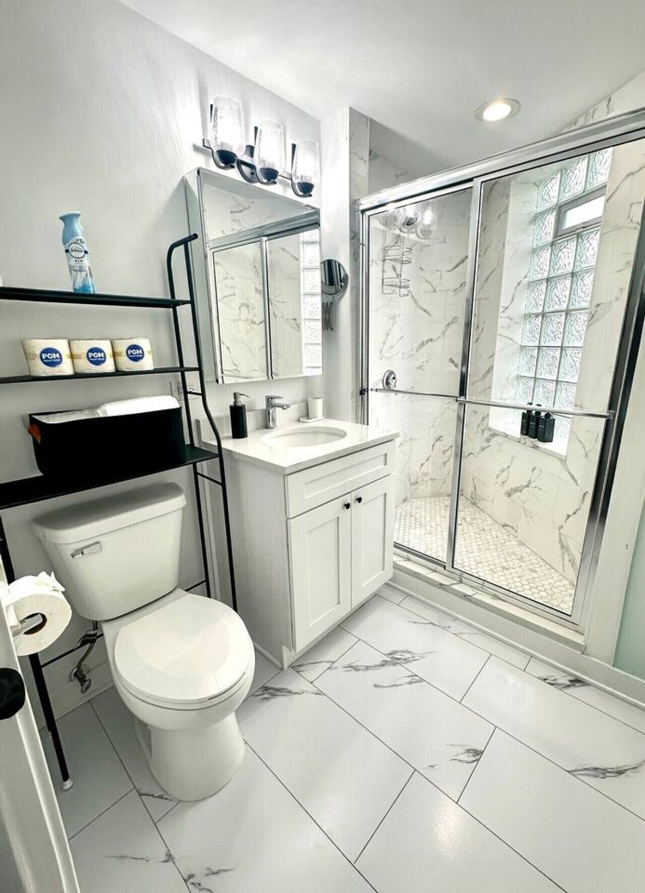 Une salle de bain moderne équipée de toilettes, d’un lavabo et d’une douche.