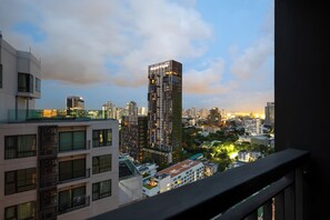 A high-rise building with 'Righton' signage, surrounded by other buildings and a cityscape. - 5 Min to Metro, Washer & Dryer, Essentials, Gym (Khet Khlong Toei)