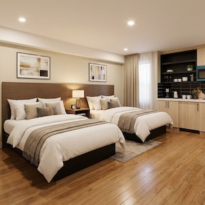 Una habitación de hotel moderna con dos camas, una kitchenette y obras de arte en las paredes.