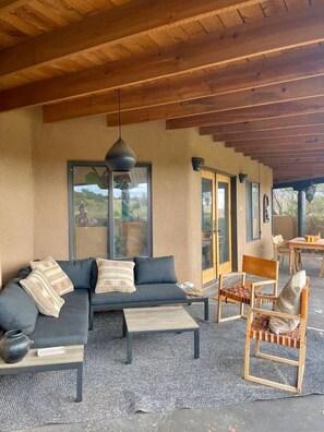 An outdoor seating area with a sofa, chairs, and a table. - Casa Encantado in Eldorado (Santa Fe)