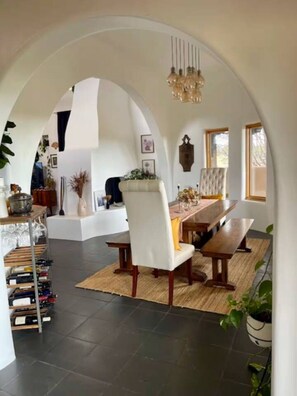 An interior with a dining area, a kitchen, and a living space. - Casa Encantado in Eldorado (Santa Fe)