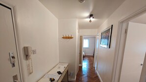 Un couloir avec un bureau, un téléphone et une porte portant le numéro 1.