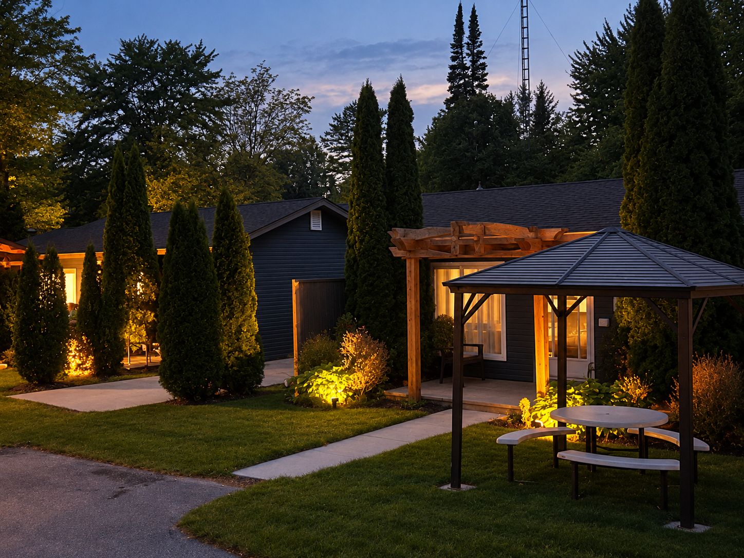 A residential property with a covered patio, a small garden, and a pathway leading to the entrance.